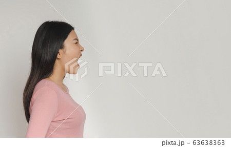Side view of asian girl screaming towards copy space 63638363