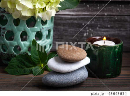 Green aroma candle in Spa still life Green aroma candle in Spa still life 63643654
