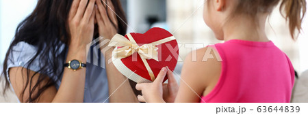 Cute little girl giving her mom birthday present 63644839