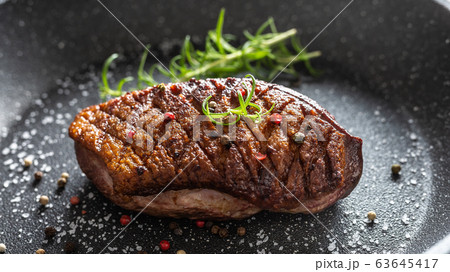 Duck breast roasted in ceramic pan with salt Duck breast roasted in ceramic pan with salt 63645417