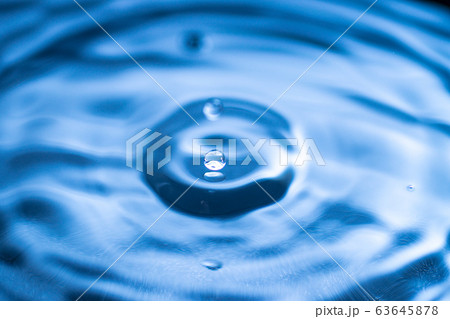 water drop splash in a glass blue colored water drop splash in a glass blue colored 63645878