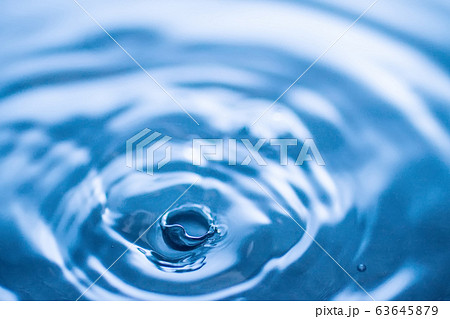 water drop splash in a glass blue colored water drop splash in a glass blue colored 63645879