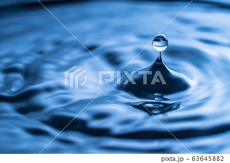 water drop splash in a glass blue colored 63645882