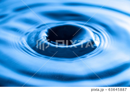 water drop splash in a glass blue colored water drop splash in a glass blue colored 63645887