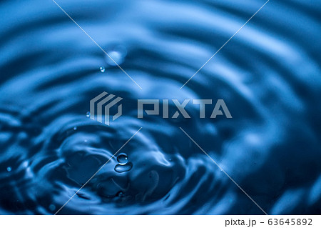 water drop splash in a glass blue colored water drop splash in a glass blue colored 63645892