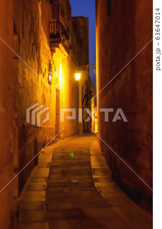 Narrow streets of Mdina, ancient capital of Malta. Night view on illuminated buildings and wall decorations of ancient town. 63647014