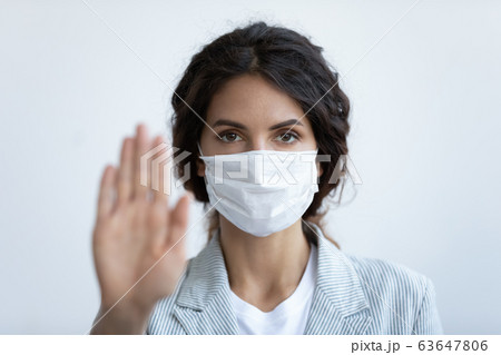 Woman in medical mask show stop gesture to stop pandemic Woman in medical mask show stop gesture to stop pandemic 63647806