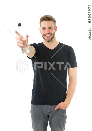 Man athlete hold water bottle. Guy drink water on Man athlete hold water bottle. Guy drink water on 63647979