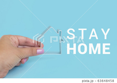 STAY HOME with housein fingers on blue background 63648458