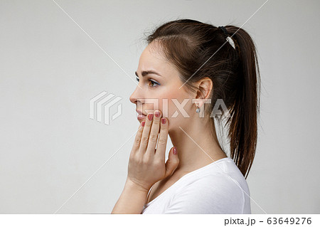 young sad woman suffering from tooth pain young sad woman suffering from tooth pain 63649276