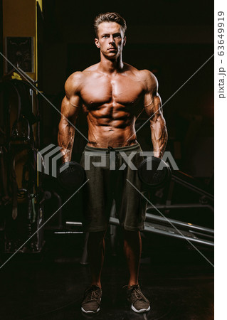 Handsome Fit Man Tightening His Muscles 63649919