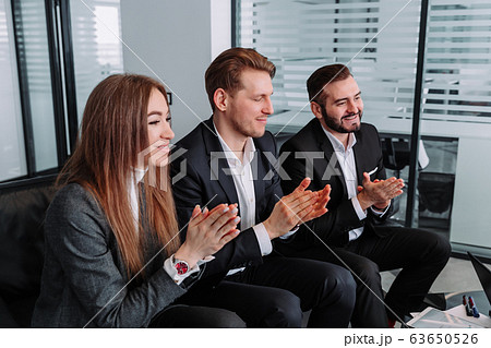 group of business people clapping hands to congratulate their boss - Business company team 63650526
