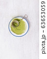 Vintage metal strainer with Matcha tea on ceramic 63653059