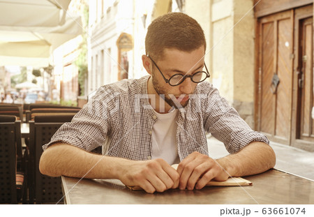 young man about to read a book young man about to read a book 63661074