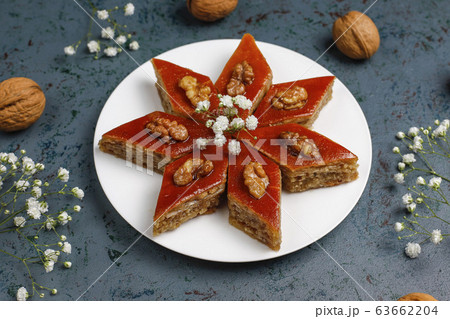 Azerbaijan national pastry pakhlava on white plate on dark background ,top view,spring new year celebration Novruz holiday. 63662204