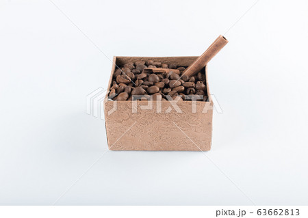 Coffee beans and cinnamons in a box on the white background Coffee beans and cinnamons in a box on the white background 63662813