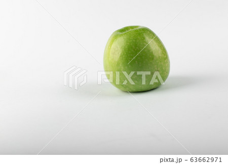 A single green fresh apple isolated on white background. side view 63662971