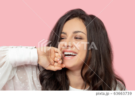 Brunette woman in a white blouse making a pose 63663739