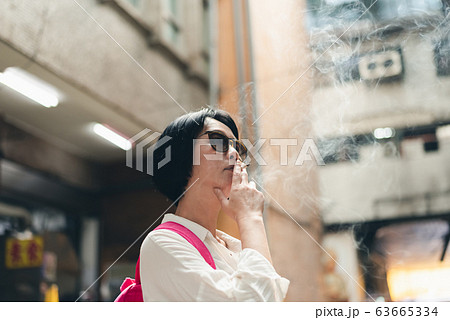 Asian woman traveling and smoking Asian woman traveling and smoking 63665334