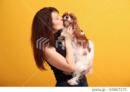 Fashion girl posing on a yellow background Fashion girl posing on a yellow background 63667273
