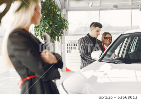 Stylish and elegant people in a car salon Stylish and elegant people in a car salon 63668013