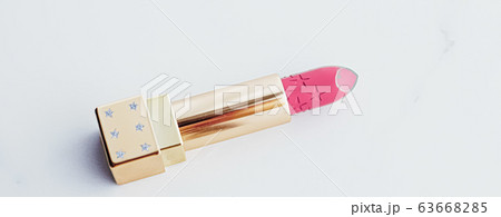 Luxury lipstick in a golden tube on white marble background, make-up and cosmetics 63668285