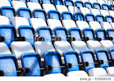 Empty tribunes in swimming pool. Modern plastic colored seats before the competition 63668426