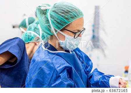 Covid-19. Female nurse puts on protective gloves. Personal protective equipment in the fight against 63672165