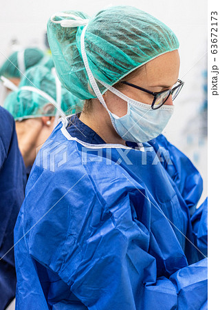 Covid-19. Female nurse puts on protective cloths. Personal protective equipment in the fight against Covid-19. Female nurse puts on protective cloths. Personal protective equipment in the fight against 63672173