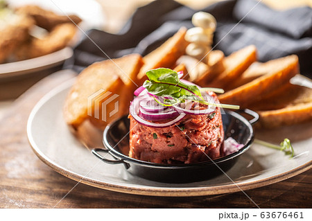 Beef tartare with red onion toast bread and garlic Beef tartare with red onion toast bread and garlic 63676461
