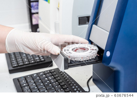 Close up view of laboratory equipment. Blood contaminated by Coronavirus and a sample of it being 63676544