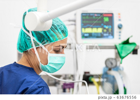 Covid-19 outbreak. Healthcare worker. Nurse working in intensive care unit. Mechanical ventilation Covid-19 outbreak. Healthcare worker. Nurse working in intensive care unit. Mechanical ventilation 63676556