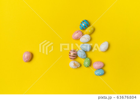 Different colorful Easter eggs on yellow 63676804
