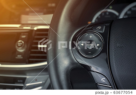 Multimedia button on multifunction steering wheel in a luxury car. 63677054
