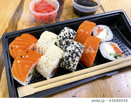 Set of rolls, ginger, soy sauce, sticks on wooden 63680056