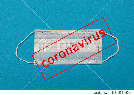 Medical disposable face mask on a blue background with the inscription stop coronavirus covid 19 63681600