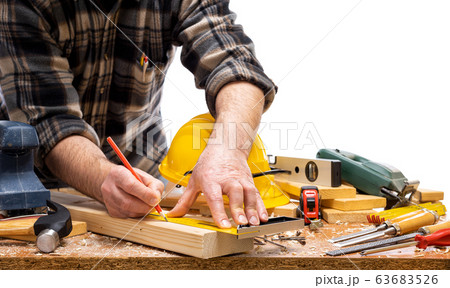 Carpenter at work on wooden boards. Carpentry. Carpenter at work on wooden boards. Carpentry. 63683526