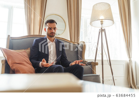 Serious young man complaining about his problems 63684455