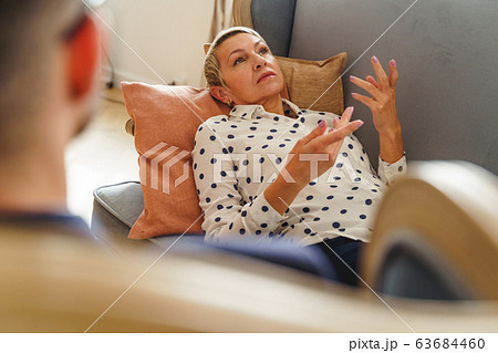Depressed female patient lying on a sofa 63684460