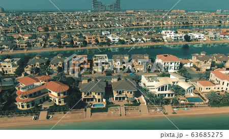 Low altitude aerial view of many luxury villas on the Palm Jumeirah island in Dubai. UAE 63685275