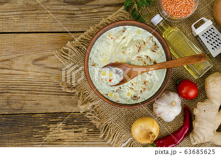 Vegetable soup with lentils in clay bowl on table Vegetable soup with lentils in clay bowl on table 63685625