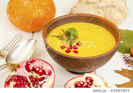 Spicy pumpkin carrot soup cream with pomegranate. Spicy pumpkin carrot soup cream with pomegranate. 63685805