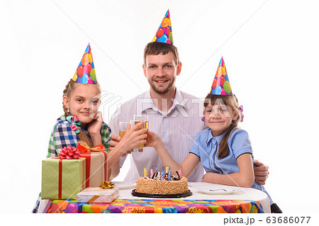 Kids and dad drink juice at a birthday party 63686077
