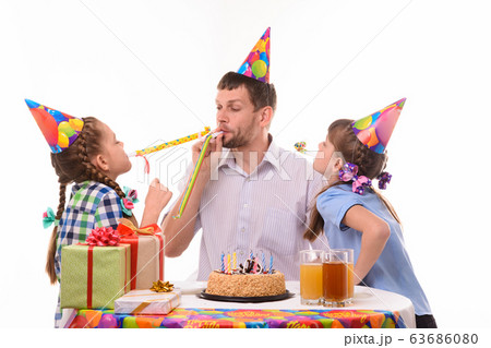 Children and dad joyfully blow whistles to the Children and dad joyfully blow whistles to the 63686080