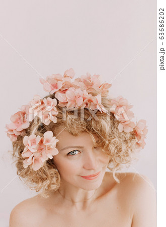 woman holiday flowers wreath pink laugh happiness woman holiday flowers wreath pink laugh happiness 63686202