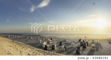 Beach scenery at sunset at North Sea. Beach chairs 63686281