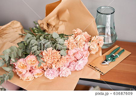 Flower set on wooden table. Fresh cut flowers for decoration home. Delivery flower. Flower set on wooden table. Fresh cut flowers for decoration home. Delivery flower. 63687609