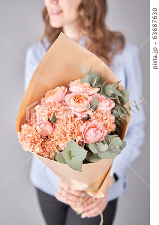 Flower set in womans hands. Fresh cut flowers for decoration home. European floral shop. Beautiful bouquet of mixed flowers . Delivery fresh cut flower. 63687630