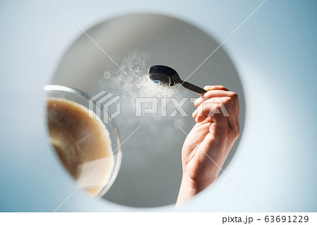 Man Adding Sugar To Coffee Viewed From Inside A Mug 63691229