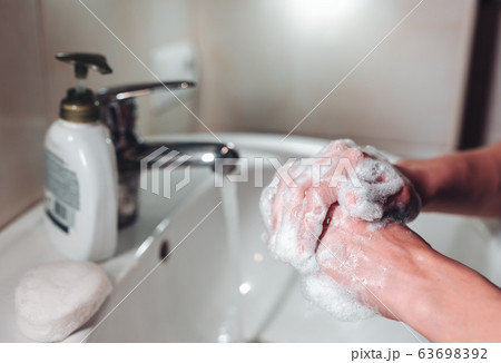 Man washing hands to protect against the coronavirus Man washing hands to protect against the coronavirus 63698392